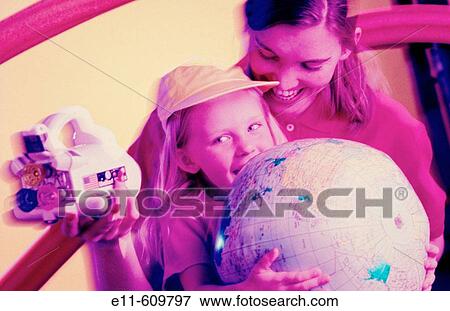 Stock Photo - Mother and daughter with space shuttle toy and globe. Fotosearch