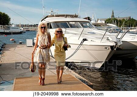 Stock Photo - Mother and daughterat the luxury boot Stockholm. Fotosearch