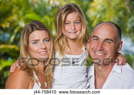 Mother and father with young blonde girl outdoors, smiling, portrait View Large Photo Image Stock Image - Mother and father with young blonde girl outdoors, smiling, portrait. Fotosearch