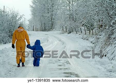 Mother and her three year old daughter walking along a snowy road, Selonnet, French Alps, France View Large Photo Image Stock Photography - Mother and her three year old daughter walking along a snowy road, Selonnet, French Alps, France. Fotosearch