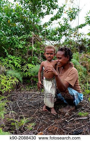 Mother and kid in the green, Papua, Indonesia, Southeast Asia. View Large Photo Image Stock Image - Mother and kid in the green, Papua, Indonesia, Southeast Asia.. Fotosearch
