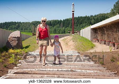Mother and Kid Walking Together Holding Hands in Estonian Road Museum, P? lva County, Estonia View Large Photo Image Stock Photo - Mother and Kid Walking Together Holding Hands in Estonian Road Museum, P? lva County, Estonia. Fotosearch