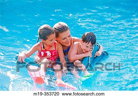 Stock Image - mother and kids in a pool. Fotosearch