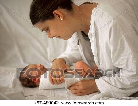 Stock Image - Mother and new born baby in maternity hospital. Fotosearch
