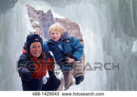 Stock Image - mother and son at an ice cave in Maligne Canyon, Jasper National Park, Alberta, Canada. Fotosearch