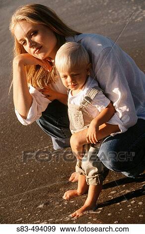 Stock Photo - Mother and son at beach. Fotosearch