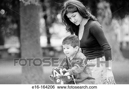 Stock Photograph - Mother and son at playground. Fotosearch