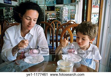 Mother and son eating ice cream together at a cafe. View Large Photo Image Stock Image - Mother and son eating ice cream together at a cafe.. Fotosearch