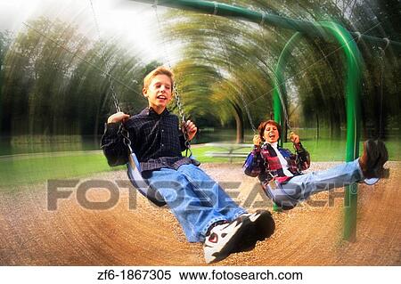 Mother and son enjoy quality time together while they swing at a local park View Large Photo Image Stock Photography - Mother and son enjoy quality time together while they swing at a local park. Fotosearch