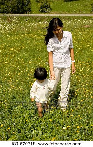 Mother and son enjoying the wild flowers of Carpatian mountains View Large Photo Image Stock Photo - Mother and son enjoying the wild flowers of Carpatian mountains. Fotosearch