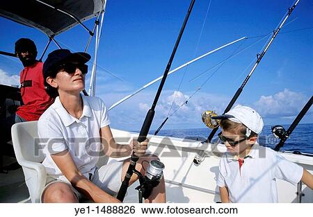 Mother and son going fishing on a boat in the Pacific Ocean, off Vanuatu. View Large Photo Image Stock Photograph - Mother and son going fishing on a boat in the Pacific Ocean, off Vanuatu.. Fotosearch