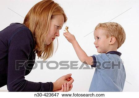 Stock Photo - Mother and son interacting with toy. Fotosearch