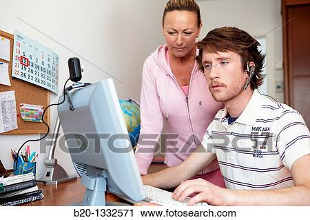 Mother and son looking at PC in room View Large Photo Image Stock Image - Mother and son looking at PC in room. Fotosearch
