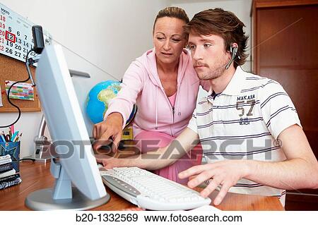 Mother and son looking at PC in room View Large Photo Image Stock Photo - Mother and son looking at PC in room. Fotosearch