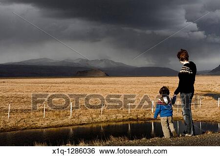 Mother and son looking at Stori-Dimon and Tindfjallajokull glacier, South Iceland View Large Photo Image Stock Photograph - Mother and son looking at Stori-Dimon and Tindfjallajokull glacier, South Iceland. Fotosearch