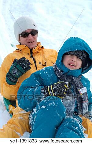 Mother and son on a sled at a ski resort in the French Alps, France View Large Photo Image Stock Image - Mother and son on a sled at a ski resort in the French Alps, France. Fotosearch