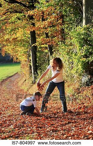 Mother and son playing with leaves in fall, having fun, autumn foliage covering path in forest, autumn, fall, Zuerich, Switzerland View Large Photo Image Stock Photo - Mother and son playing with leaves in fall, having fun, autumn foliage covering path in forest, autumn, fall, Zuerich, Switzerland. Fotosearch