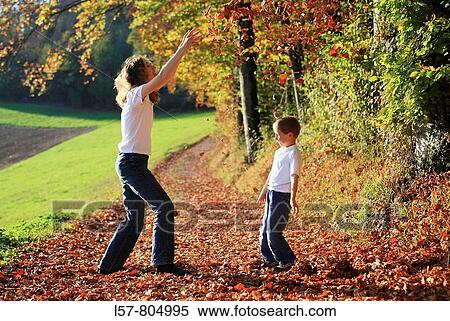 Mother and son playing with leaves in fall, having fun, autumn foliage covering path in forest, autumn, fall, Zuerich, Switzerland View Large Photo Image Stock Photography - Mother and son playing with leaves in fall, having fun, autumn foliage covering path in forest, autumn, fall, Zuerich, Switzerland. Fotosearch