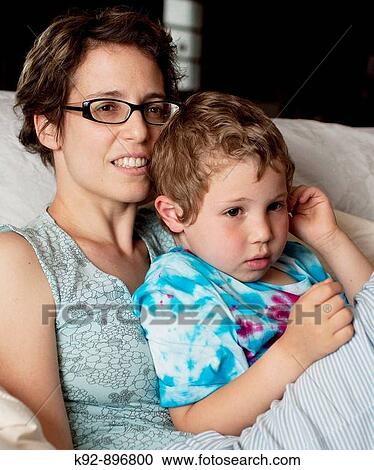 Mother and son watching television View Large Photo Image Stock Image - Mother and son watching television. Fotosearch