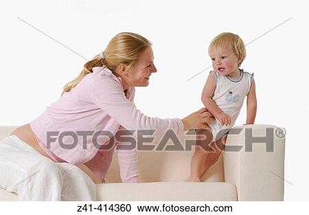 Stock Image - Mother and toddler at a bench. Fotosearch