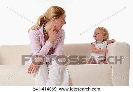 Stock Photo - Mother and toddler at a bench. Fotosearch
