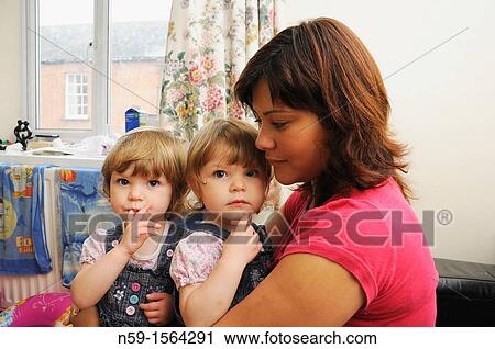 Mother and twin girls at home View Large Photo Image Stock Image - Mother and twin girls at home. Fotosearch
