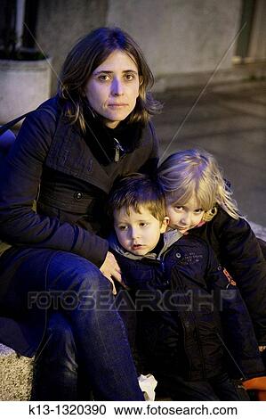 Mother and two children, ages 4 and 6, smiling into camera View Large Photo Image Stock Image - Mother and two children, ages 4 and 6, smiling into camera. Fotosearch