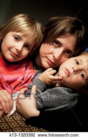 Mother and two children, ages 4 and 6, smiling into camera View Large Photo Image Stock Image - Mother and two children, ages 4 and 6, smiling into camera. Fotosearch