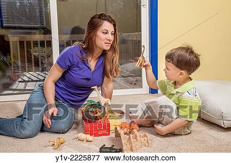 Stock Photo - Mother and young son playing with his toys.. Fotosearch