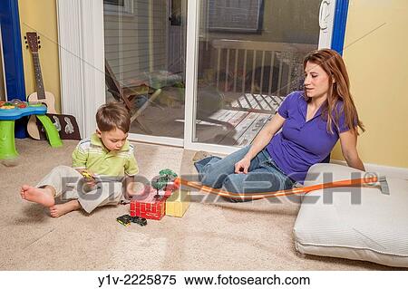 Mother and young son playing with his toys. View Large Photo Image Stock Photography - Mother and young son playing with his toys.. Fotosearch