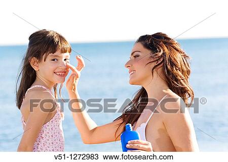 Mother applying sun protection cream to her daughter View Large Photo Image Stock Image - Mother applying sun protection cream to her daughter. Fotosearch
