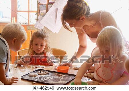 Mother baking with a group of children View Large Photo Image Stock Photo - Mother baking with a group of children. Fotosearch