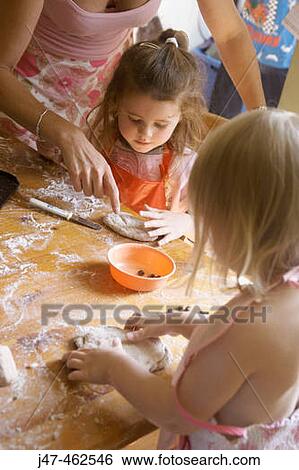 Mother baking with a group of children View Large Photo Image Stock Photograph - Mother baking with a group of children. Fotosearch