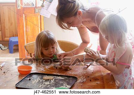Mother baking with two three year old girls. View Large Photo Image Stock Image - Mother baking with two three year old girls.. Fotosearch