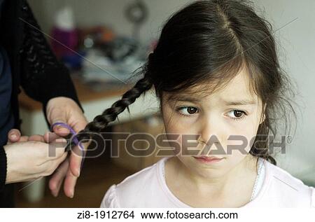 Mother braids girls hair View Large Photo Image Picture - Mother braids girls hair. Fotosearch