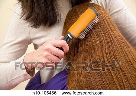 Mother brushing the hair of her preteen redhead daughter View Large Photo Image Stock Image - Mother brushing the hair of her preteen redhead daughter. Fotosearch