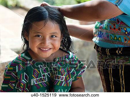 Mother combing mayan girls hair View Large Photo Image Stock Photo - Mother combing mayan girls hair. Fotosearch