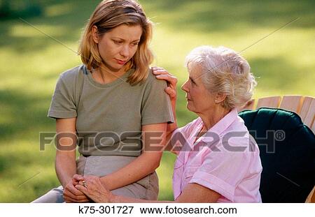 Stock Photo - Mother consoling her adult daughter. Fotosearch