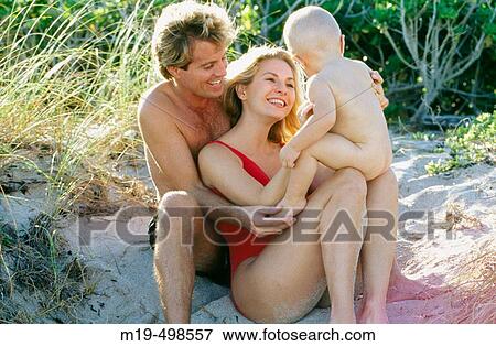 mother & father with baby at the beach View Large Photo Image Stock Photo - mother & father with baby at the beach. Fotosearch