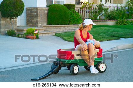 mother feeding baby in wagon View Large Photo Image Picture - mother feeding baby in wagon. Fotosearch