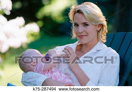 Picture - Mother feeding her new baby. Fotosearch