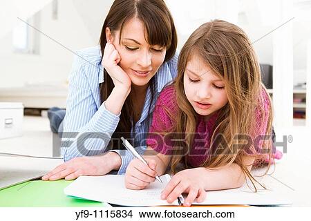 Mother Helping Daughter with Homework View Large Photo Image Picture - Mother Helping Daughter with Homework. Fotosearch