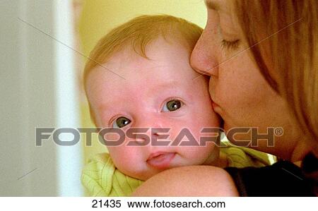 Mother holding and kissing baby boy View Large Photo Image Stock Photography - Mother holding and kissing baby boy. Fotosearch