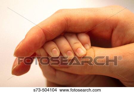 Mother holding baby's hand View Large Photo Image Picture - Mother holding baby's hand. Fotosearch