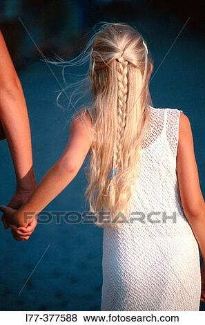Mother holding hand of her daughter View Large Photo Image Stock Photo - Mother holding hand of her daughter. Fotosearch