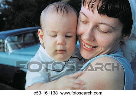 Mother holding her baby boy in the 1960s View Large Photo Image Stock Photo - Mother holding her baby boy in the 1960s. Fotosearch