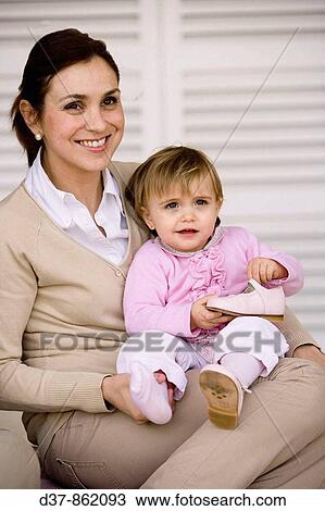 Stock Image - Mother holding her daughter. Fotosearch