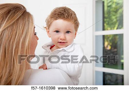 Mother holding her oneyear old boy View Large Photo Image Stock Photo - Mother holding her oneyear old boy. Fotosearch