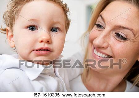 Mother holding her oneyear old boy View Large Photo Image Stock Photography - Mother holding her oneyear old boy. Fotosearch