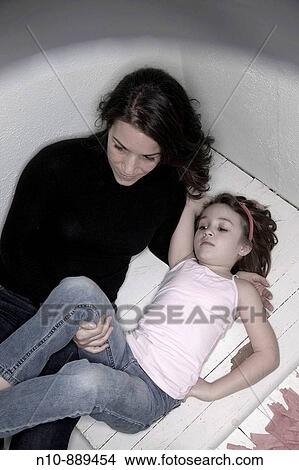 Picture - Mother holding her young daughter. Model and Property Released.. Fotosearch